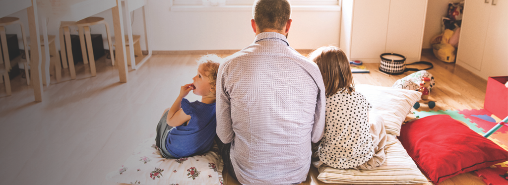 father and two daughters sitting together