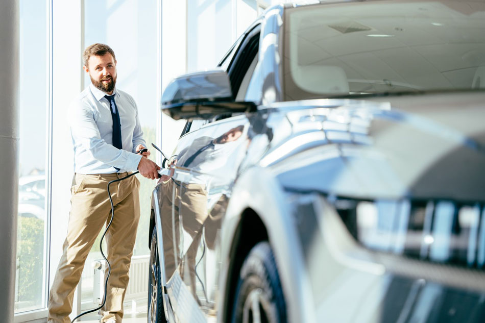 Man charging electric vehicle