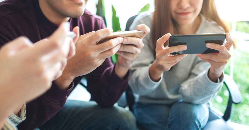 People engaging with cell phone